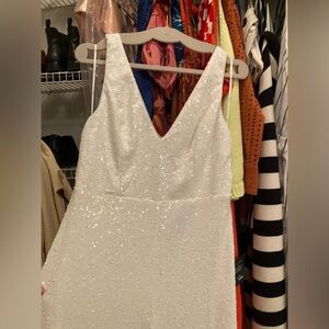 White sequin jumpsuit with bow in back. Bow is detachable.